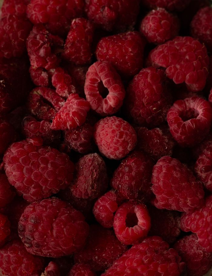 A detailed close-up of ripe red raspberries showcasing their vibrant color and texture.